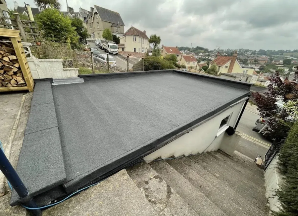 Finished flat roof in grey mineral felt on a garage, fitted by Expert Roofing Services