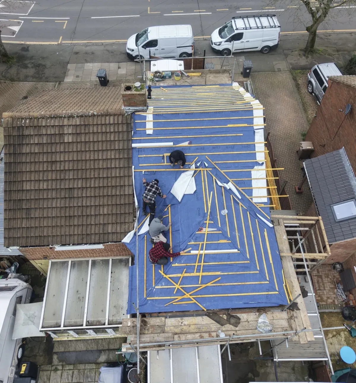 Aerial view of the Expert Roofing Services team fitting breathable membrane and battens on a new hipped roof